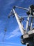 Port crane silhouette against deep blue sky