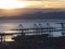 Port cranes cargo ship and container above view at sunset