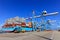 Port dock with container ship and Various brands and colors of shipping containers stacked in a holding platform