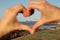 Port Elizabeth Shark Rock pier enclosed by out of focus hands making the shape of a heart