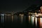 The port of Gargnano, Italy at night with bright lights and long part of coast