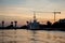 The port in Kaliningrad. Silhouettes of cranes and ships on sunset background harbor