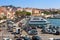 Port of La Maddalena in Italy. Boats, tourists and cars.