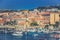 Port of La Maddalena in Italy. Boats, tourists and cars.