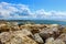 A port made of rocks. Wavy sea and cloudy windy weather