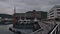 Port of Norwegian city TromsÃ¸ with docking boats in calm water and hotel Scandic Ishavshotel (modern architecture).