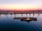 Port river cranes loading ships on barges delivery, sunset