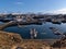 Port of small fishing village Stykkisholmur on the shore of BreiÃ°afjÃ¶rÃ°ur fjord on sunny winter day with mountains.