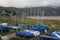 Port of small and large sailboats parked and sailing on the lake of Valle de Bravo in Mexico at sunset