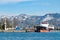 Port view - ships in the harbor, a lighthouse, snowy mountains in the background