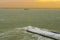 The port of vlissingen at sunset with a boat sailing by, landscape of a wild sea, Zeeland, The Netherlands