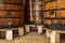 Port wine maturing at wooden barrel, cellar interior in Porto Oporto town