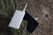 A portable charger charges the Tablet. Power Bank with cable against the background of nature and wood