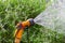 Portable garden automatic plastic pipe irrigation system with a mounted shower spray head watering lawn