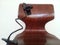 Portable mobile phone holder with long cord attached to wooden chair
