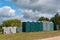 Portable mobile toilets and plastic hand washing sink stations on the public park