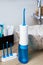 Portable oral irrigator kit in bathroom, waterpik for family use