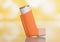 Portable pocket inhaler for asthmatics, on yellow