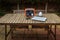 Portable power station solar electricity generator on table with laptop, cell phone, lamp charging.