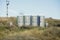 Portable public toilets in the middle of a field on a sunny winter day