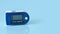 Portable Pulse oximeter isolated on blue background.Copy space for text