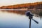 Portable recorder stands on a tripod on the lake shore