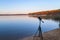 Portable recorder stands on a tripod on the lake shore