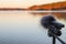 Portable recorder stands on a tripod on the lake shore