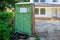 Portable restroom on house under construction with new house