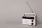 Portable retro radio receiver on grey background. Space for text