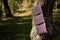 A portable solar panel hangs on a tree in the sun. Charging electronic gadgets on a hike, during outdoor recreation. Ecological