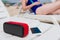 Portable speaker, phone and woman at background