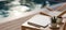 A portable tablet mockup is on a wooden outdoor side table over blurred swimming pool