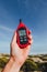 Portable thermometer in hand measuring outdoor air temperature and humidity