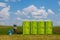 Portable toilet on the grass on a background of clouds