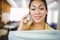 Portait of businesswoman holding files while using mobile phone in cafeteria