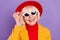 Portait of cheerful short hairdo aged lady wear yellow jacket cap eyewear isolated on purple background
