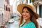 Portait of smiling cheerful woman with hat and green dress in he