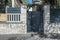 Portal of an urban single-family house with a metal fence painted gray