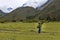 Porter carrying an heavy backpack in the Inca Trail do Machu Pichu, in the mountains around the Sacred Valley