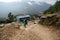 Porter carrying heavy loads on the way to Everest base camp in Easter Nepal