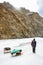 Porter Crossing Frozen Zanskar River. Chadar Trek