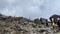 Porters with buckets of water on their heads go uphill. Climbing Kilimanjaro, Africa. Beautiful mountain landscape