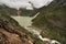 Porters carrying luggage at Tisu Top and alpine lake background,