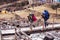 Porters of Himalaya Mountain expedition crossing wooden bridge