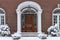 Portico entrance with elegant wood grain front door,