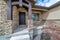 Portico and porch at the entrance of a house with stone brick exterior wall