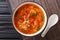 Portion of Asian tomato egg soup close-up in a bowl. horizontal top view