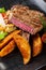 Portion of beef steak served with roast potatoes