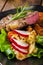 Portion of beef steak served with roast potatoes